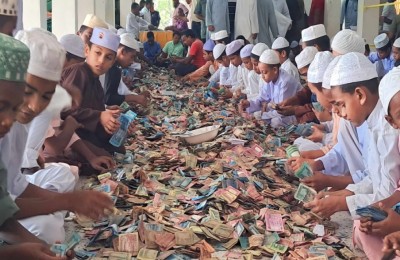 Young volunteers counting and organizing the large amounts of money collected as donations.